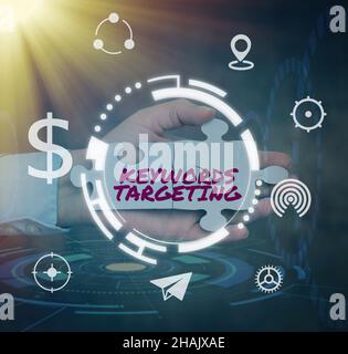 Handwriting text Keywords Targeting. Business approach Use Relevant Words to get High Ranking in Search Engines Hand Holding Jigsaw Puzzle Piece Stock Photo