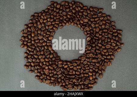 Close Up of Coffee Beans with a Hole in the Middle  on Dark Background with Copy Space Stock Photo
