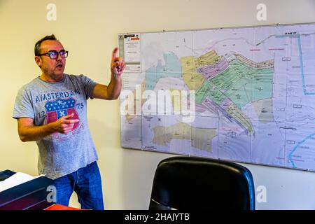 Modern olive oil mill Chateau de Taurenne in Aups, France. Manager Yann Fernandez shows the plantations on the Taurrenne site plan. Each color represents a different variety of olive tree. And each variety has a different harvest time Stock Photo