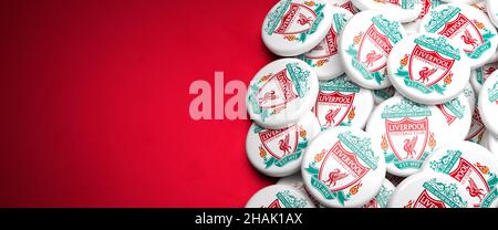 Logos of the English Soccer Club FC Liverpool on a heap on a table. Copy space. Web banner format Stock Photo