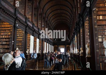 Dublin, Ireland: people visiting the Long Room of the Old Library at Trinity College Stock Photo