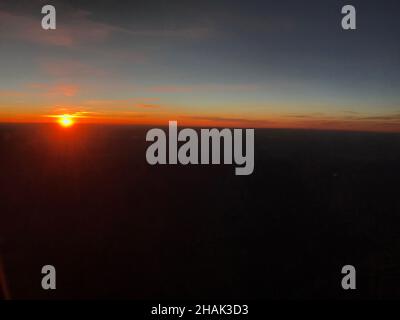 Sunset over clouds viewed from an airplane in flight Stock Photo