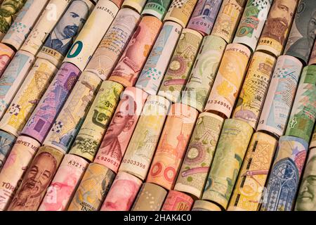 Different colourful banknotes from various countries on rolls to be used for illustrating subjects as business, banking, media etc. Stock Photo