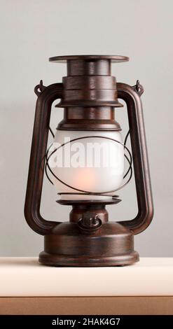 brown solar lamp on books different shades of brown, gray background Stock Photo