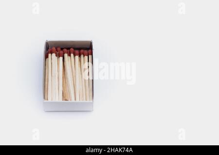High-angle shot of a box of matches on a white table with a copy space Stock Photo