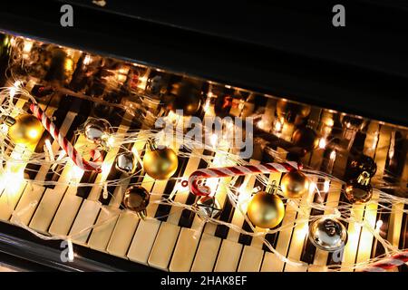 Christmas decor with glowing lights on piano keys Stock Photo