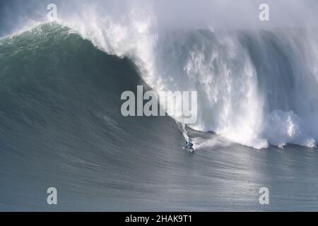 Nazare, Portugal. 12th Dec, 2021. Big wave surfer Axier Muniain from Basque Country competes during the Tudor Nazare Tow Surfing Challenge at Praia do Norte in Nazare, Portugal on December 12, 2021. (Credit Image: © Pedro Fiuza/ZUMA Press Wire) Credit: ZUMA Press, Inc./Alamy Live News Stock Photo