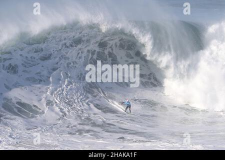 Nazare, Portugal. 12th Dec, 2021. Big wave surfer Axier Muniain from Basque Country competes during the Tudor Nazare Tow Surfing Challenge at Praia do Norte in Nazare, Portugal on December 12, 2021. (Credit Image: © Pedro Fiuza/ZUMA Press Wire) Credit: ZUMA Press, Inc./Alamy Live News Stock Photo