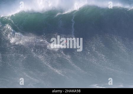 Nazare, Portugal. 12th Dec, 2021. Big wave surfer Lucas Chianca Chumbo from Brazil competes during the Tudor Nazare Tow Surfing Challenge at Praia do Norte in Nazare, Portugal on December 12, 2021. (Credit Image: © Pedro Fiuza/ZUMA Press Wire) Credit: ZUMA Press, Inc./Alamy Live News Stock Photo