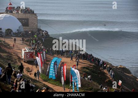 Nazare, Portugal. 12th Dec, 2021. People watch as a big wave surfer competes during the Tudor Nazare Tow Surfing Challenge at Praia do Norte in Nazare, Portugal on December 12, 2021. (Credit Image: © Pedro Fiuza/ZUMA Press Wire) Credit: ZUMA Press, Inc./Alamy Live News Stock Photo