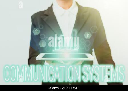 Hand writing sign Communication Systems. Conceptual photo Flow of Information use of Machine to transmit signals Woman In Suit Standing Using Device Stock Photo