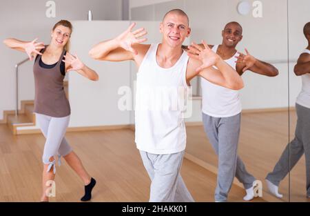Cheerful man practicing dance moves in choreographic studio Stock Photo