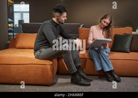 Concentrated furniture buyer setting signature to document Stock Photo