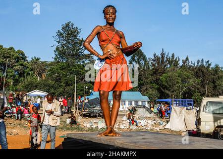 Nairobi, Kenya. 11th Dec, 2021. A young female model dressed in a colorful  outfit poses by the streets during the Mr. and Mrs. Kibera modeling contest  in Kibera Slums. Young models and