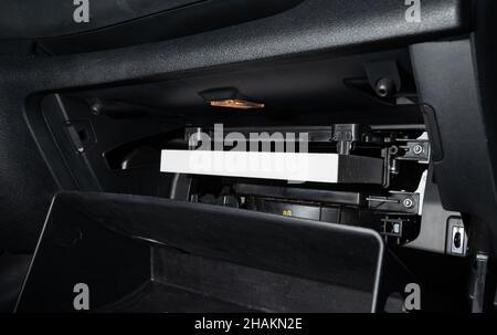 Changing the air filter inside the car. car maintenance. Stock Photo