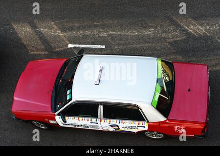 A red Toyota Comfort taxis in Hong Kong. Stock Photo