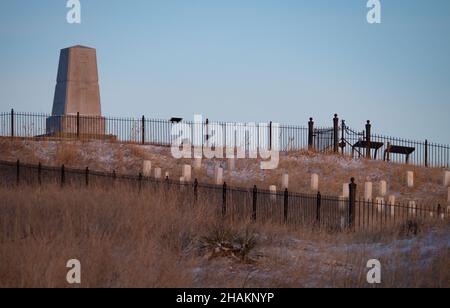 Monument and white grave markers on the hillside of Custer's Last Stand at the Little Bighorn Battlefield National Monument. Stock Photo