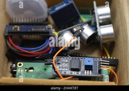 I2C LCD module and ultrasonic distance sensor along with other electronic components in a box Stock Photo