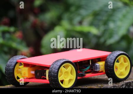 Programmable four wheels drive or 4WD robotic car with chassis. Hobby electronics project Stock Photo