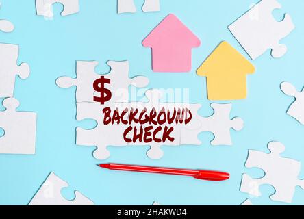 Hand writing sign Background Check. Internet Concept way to discover issues that could affect your business Building An Unfinished White Jigsaw Stock Photo