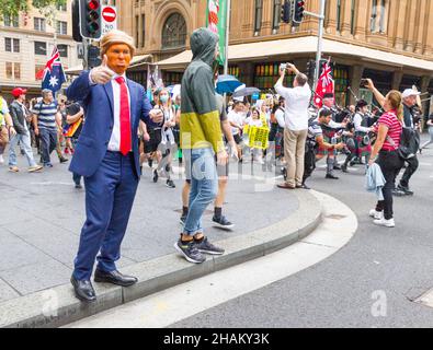 The World Wide Freedom Day Rally, held in Sydney, Australia on 20 November 2021 to protest coronavirus restrictions and lockdowns. The event commenced in Hyde Park and was followed by a protest march through city streets and speeches and performances in Martin Place. Pictured: a Donald Trump impersonator in the protest on Market Street at York Street with the Queen Victoria Building in the background. Stock Photo