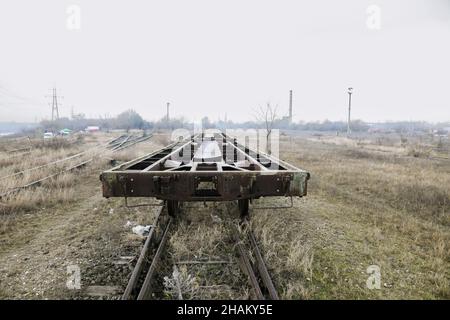 Shallow depth of field (selective focus) image with old and rusty railway industrial transportation waggon (dresine). Stock Photo