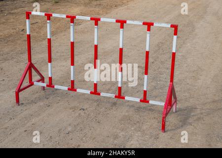 Red and white steel fence barrier restricted area Stock Photo
