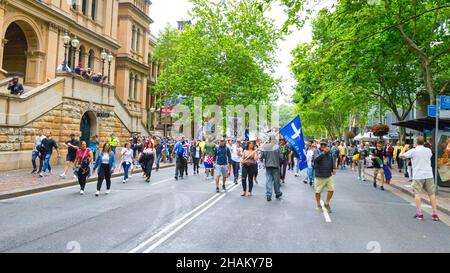 The World Wide Freedom Day Rally, held in Sydney, Australia on 20 November 2021 to protest coronavirus restrictions and lockdowns. The event commenced in Hyde Park and was followed by a protest march through city streets and speeches and performances in Martin Place. Pictured: protesters on Macquarie Street near Martin Place and NSW Parliament House. Stock Photo