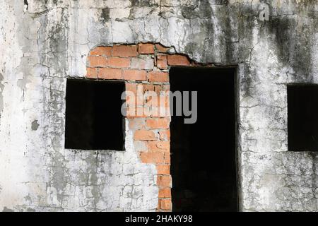 Shallow depth of field (selective focus) image with an abandoned building in a field near an old railway on a winter day. Stock Photo