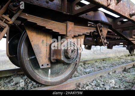 Shallow depth of field (selective focus) image with old and rusty railway industrial transportation waggon (dresine). Stock Photo