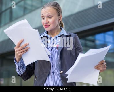 Professional woman in jacket working with documents Stock Photo