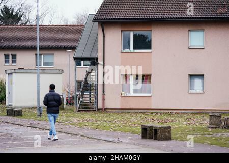 Heidelberg, Germany. 08th Dec, 2021. A resident walks past homes at the