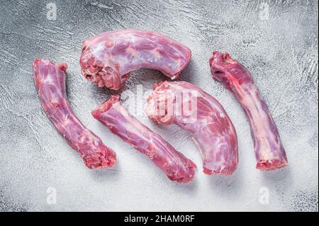 Raw Turkey neck meat on a butcher table. White background. Top View Stock Photo