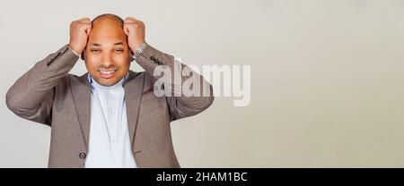 African American man holding hands behind his head with scared f Stock Photo