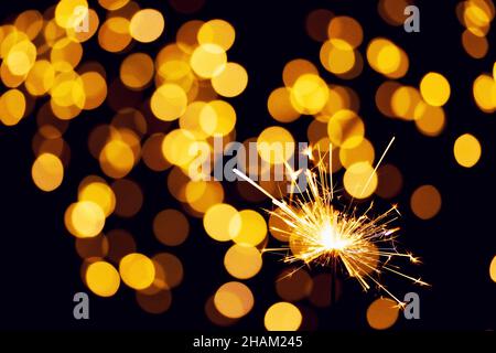 burning sparkler or bengal light on bokeh background Stock Photo