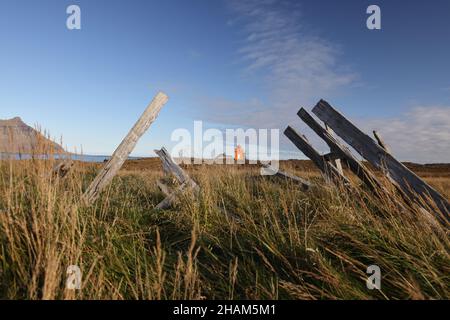 The tiny, orange Hafnarnes lighthouse of eastern Iceland Stock Photo