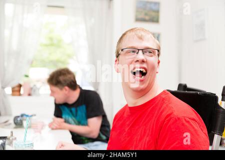 Smiling young disabled man in eyeglasses Stock Photo