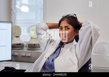Portrait of female engineer sitting at work station Stock Photo