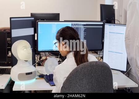 Female engineer working on robot Stock Photo