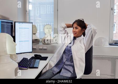 Female engineer sitting at work station Stock Photo