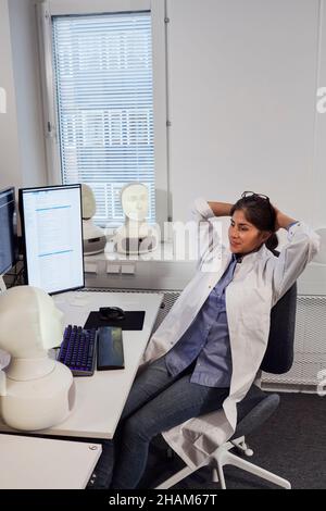 Female engineer sitting at work station Stock Photo