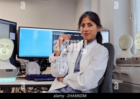 Portrait of female engineer at work station Stock Photo