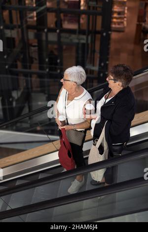 Women on escalator, high angle view Stock Photo