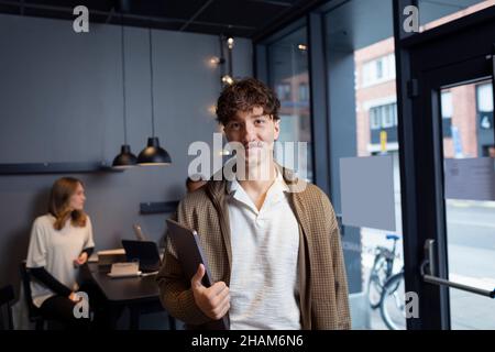 Smiling man in office looking at camera Stock Photo