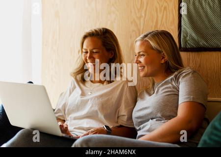 Smiling women using laptop Stock Photo