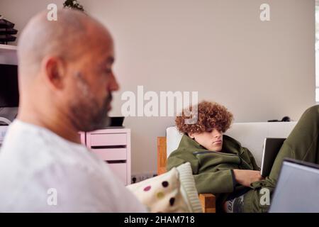 Father and son using laptops Stock Photo