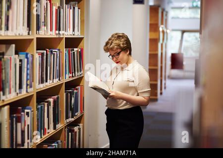 Young female student in library Stock Photo