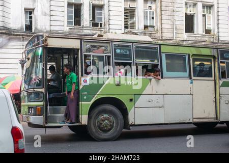 YANGON, MYANMAR - JANUARY 4, 2016: Local buses on the streets of downtown Yangon , Myanmar on January 4, 2016 Stock Photo