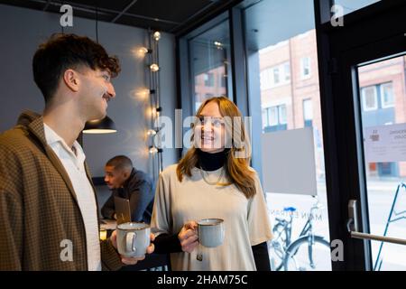 Coworkers having coffee break in office Stock Photo