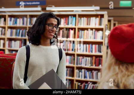 Two students talking in library Stock Photo